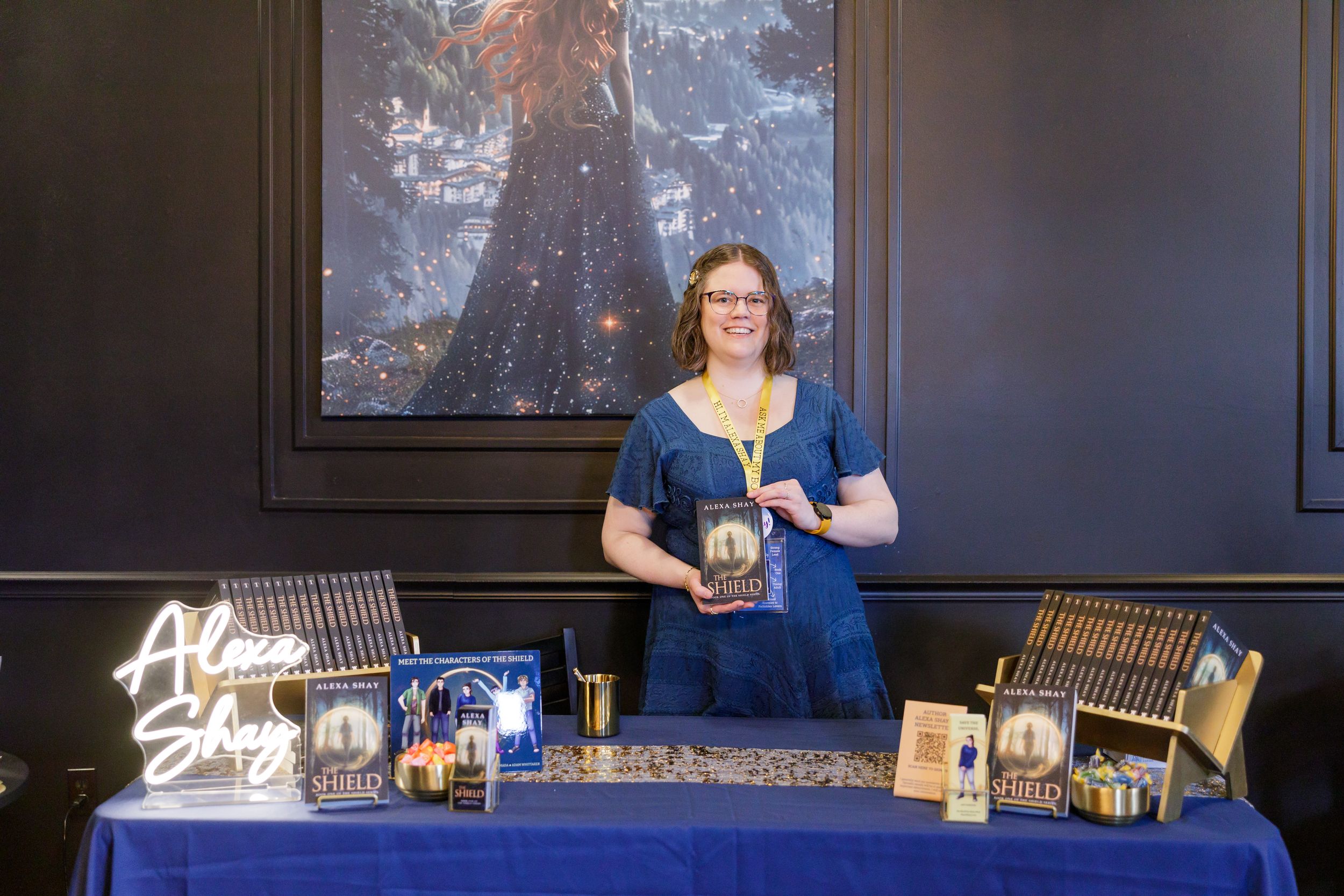 indie book author Alexa Shay author signing event in Seattle, WA bookstore standing at display table holding book smiling