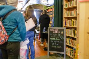 indie book author Alexa Shay author signing event in Seattle, WA bookstore readers standing in line waiting for signature with event signage