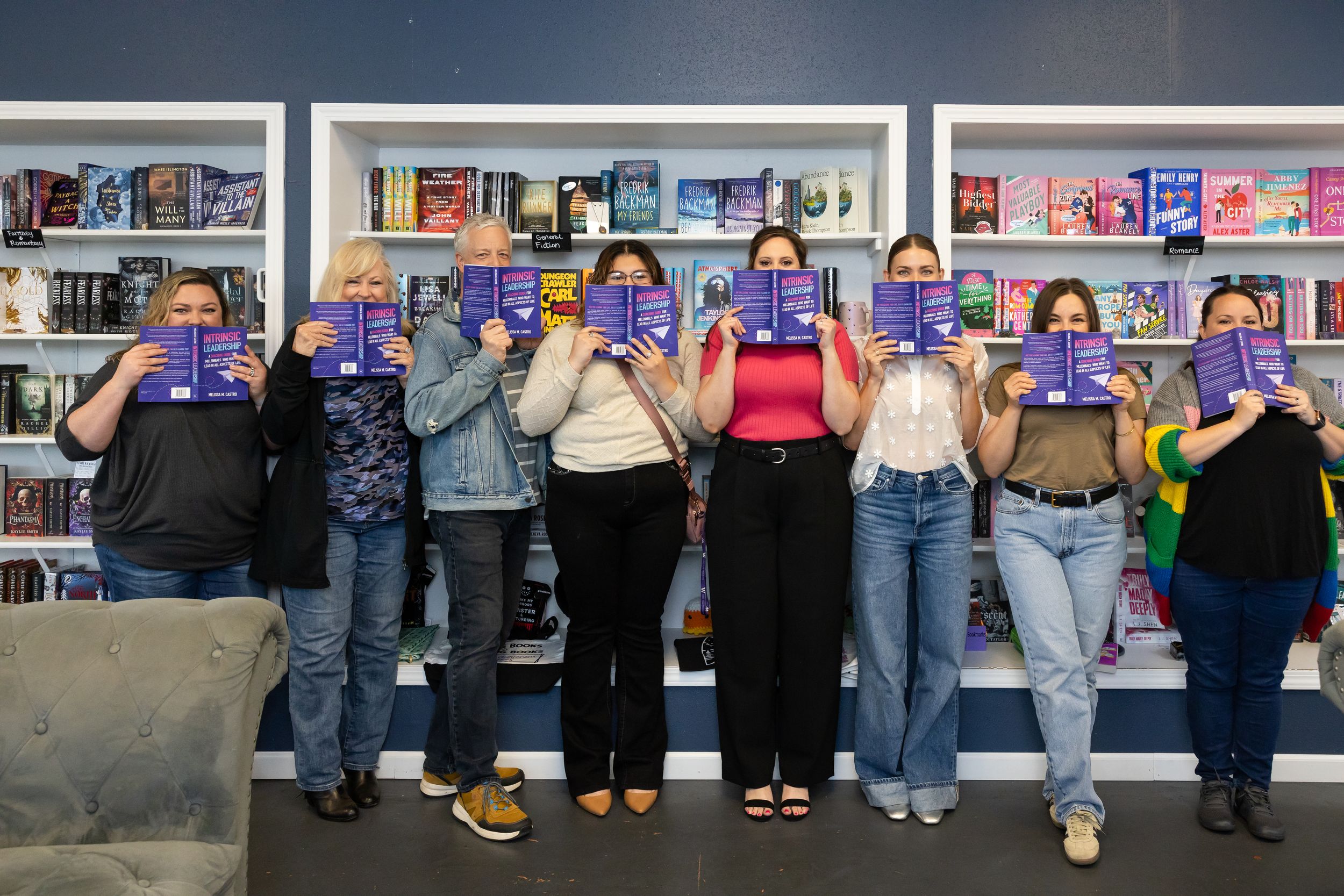 self published author Melissa Castro book signing event in Seattle, WA group of readers and friends holding book in front of face silly