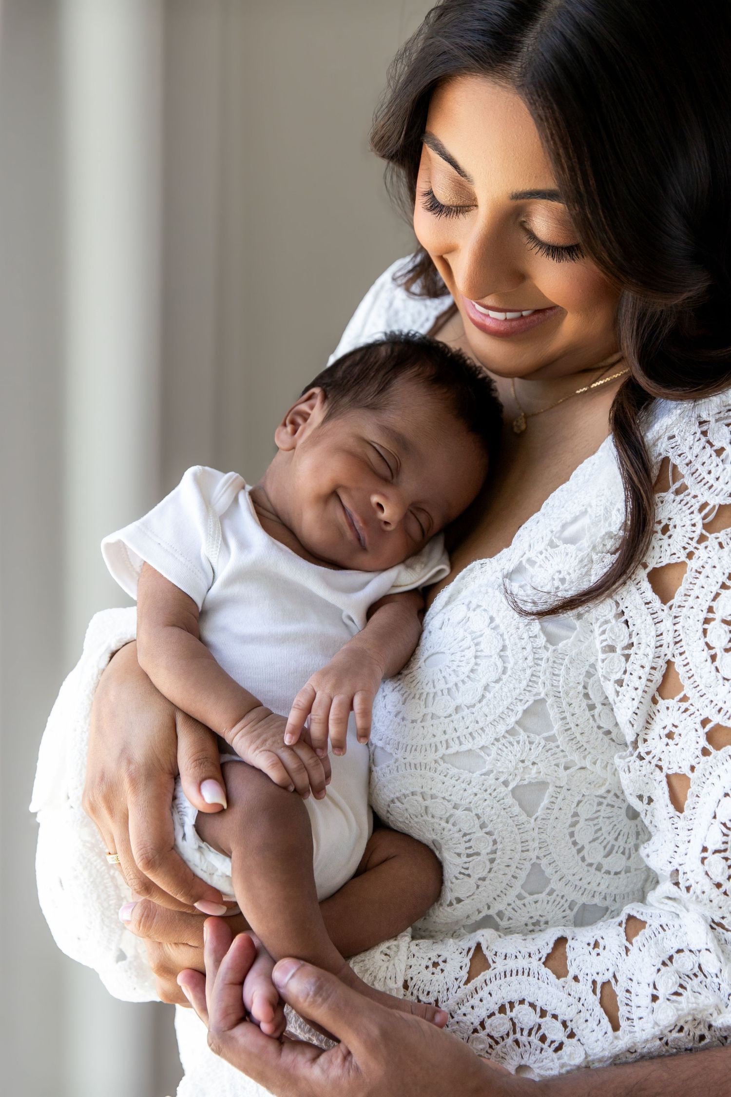 Carlene Thurston Photography - at-home newborn photoshoot mum and baby - baby is looking straight into the lens while mum looks down at baby