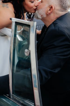 Intimate moment captured through glass with artistic blur and composition.