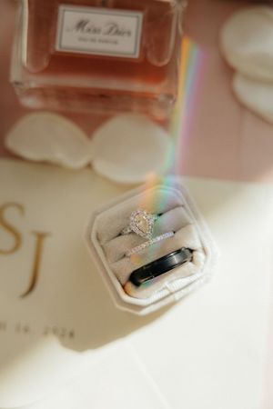 Wedding rings photographed with a soft focus and rainbow light effect.