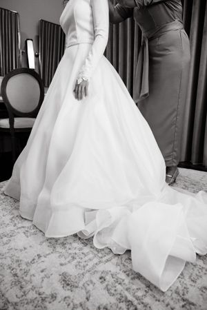 Black and white detail shots of a wedding dress hem and floor.