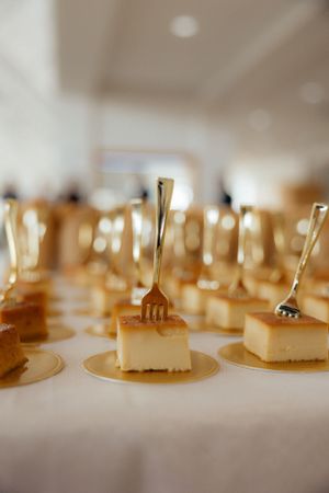 Close-up view of small dessert bites arranged on golden plates.