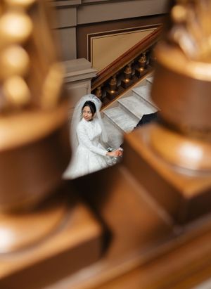 An artistic wedding photo taken from above showing a bride's white dress.