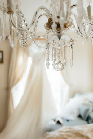 Crystal chandelier details with hanging prisms in soft natural light.