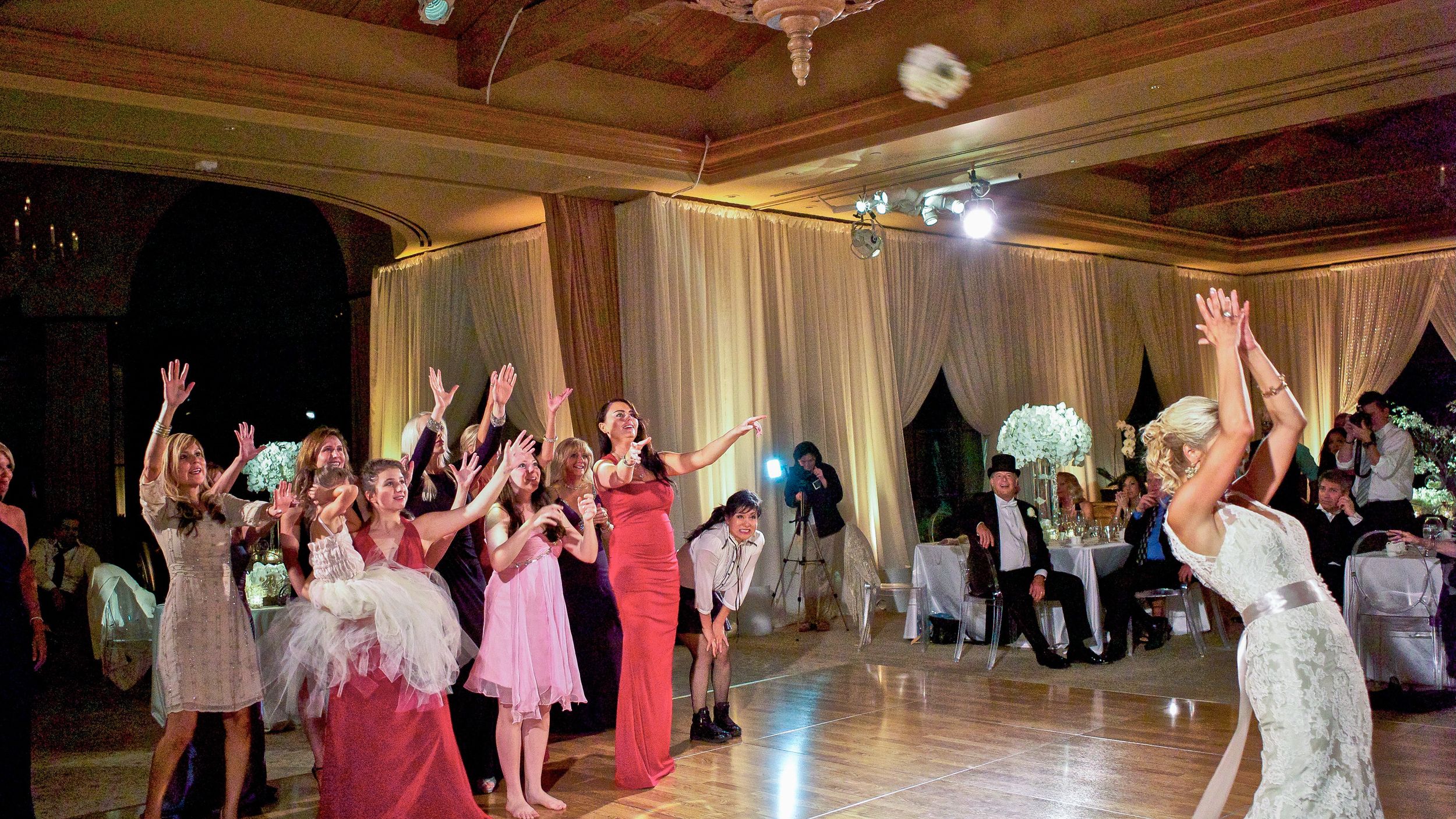 Boquet throwing in Newport, California.  The bride can throw a fast and high-flying bouquet without a doubt.  Pellican Hills.