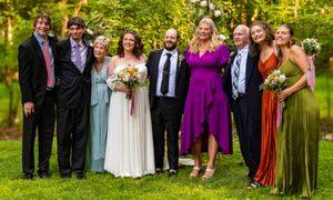 A wedding party group poses after a heartfelt wedding ceremony in the North Carolina woods near Chapel Hill.