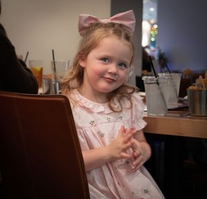 Sweet kid at Christmas time showing interest in the boys at your table.