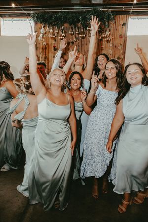 Four sequential photos show wedding party guests in light colored dresses dancing and celebrating at a reception.
