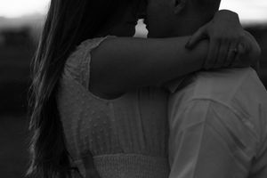 Couple sharing intimate embrace in black and white romantic photography.
