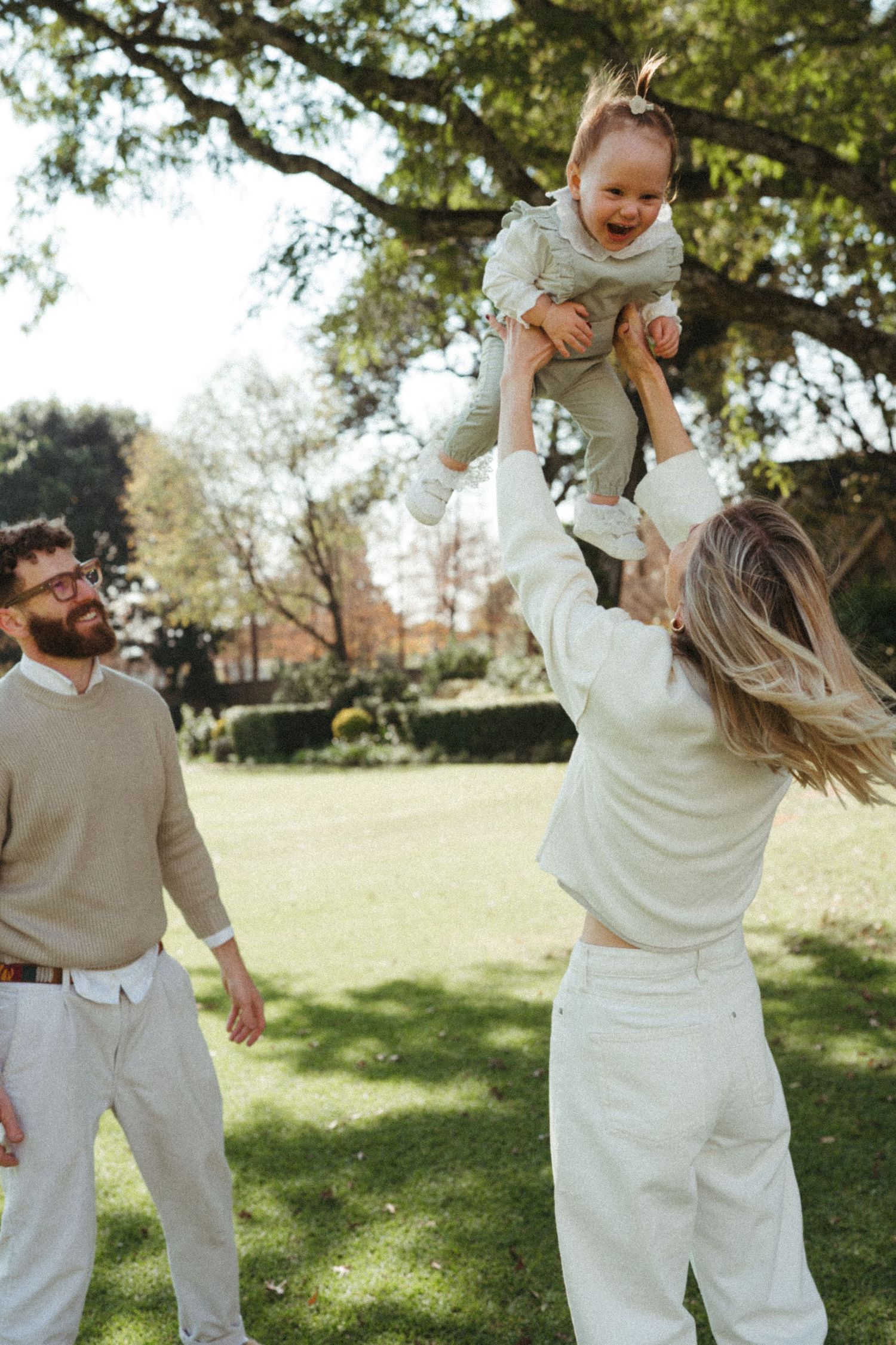 A series of playful family interactions captured in a sunny park setting with coordinated outfits.