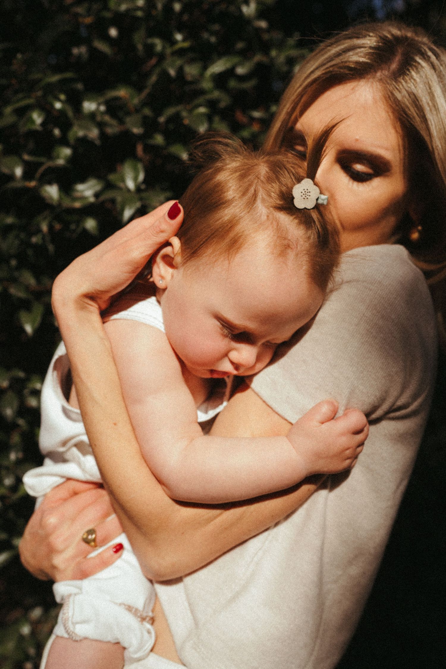 Tender moment of parent and child sharing an intimate embrace in a series of connected photos.