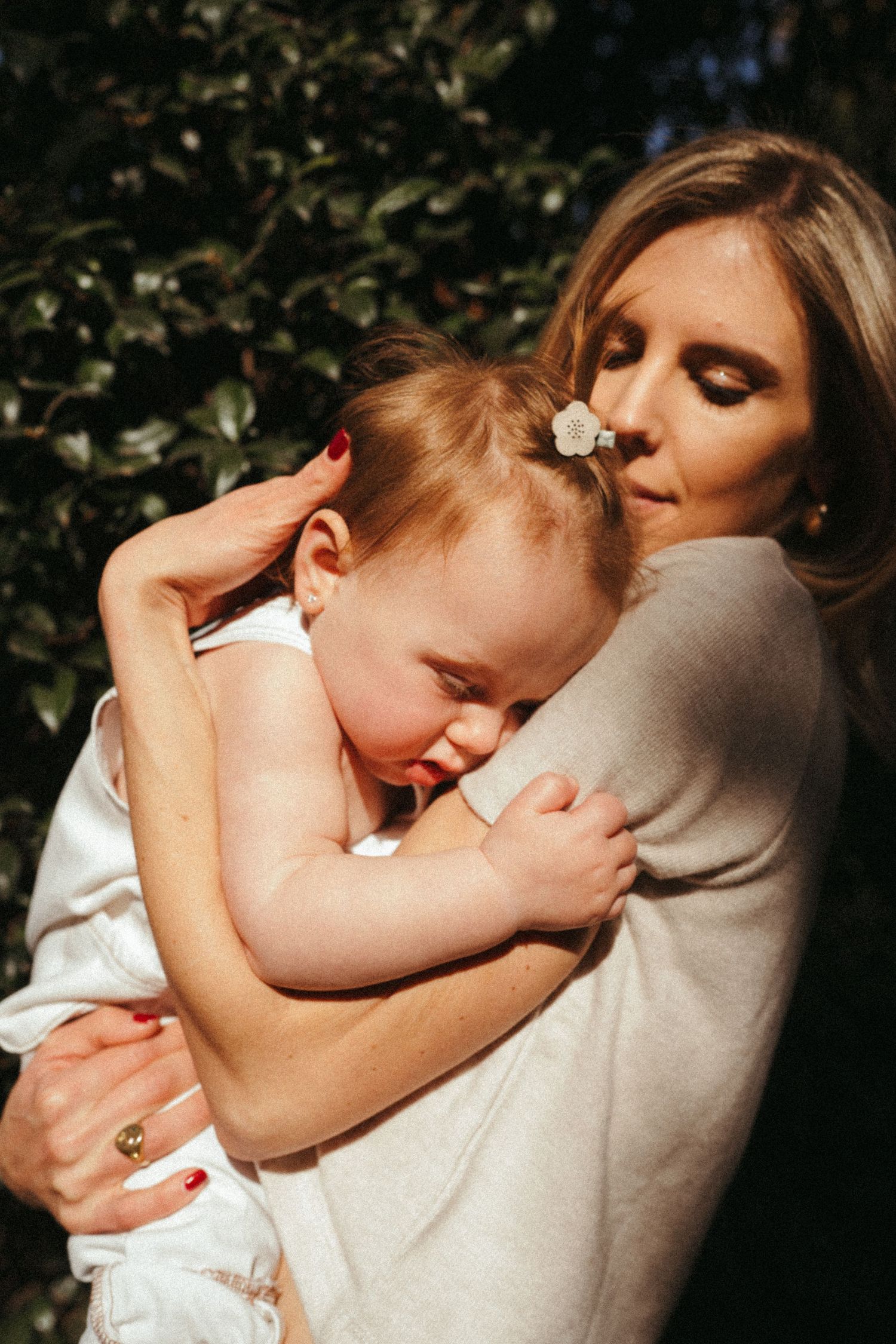 Emotional sequence showing a parent and child in a loving embrace against a dark background.