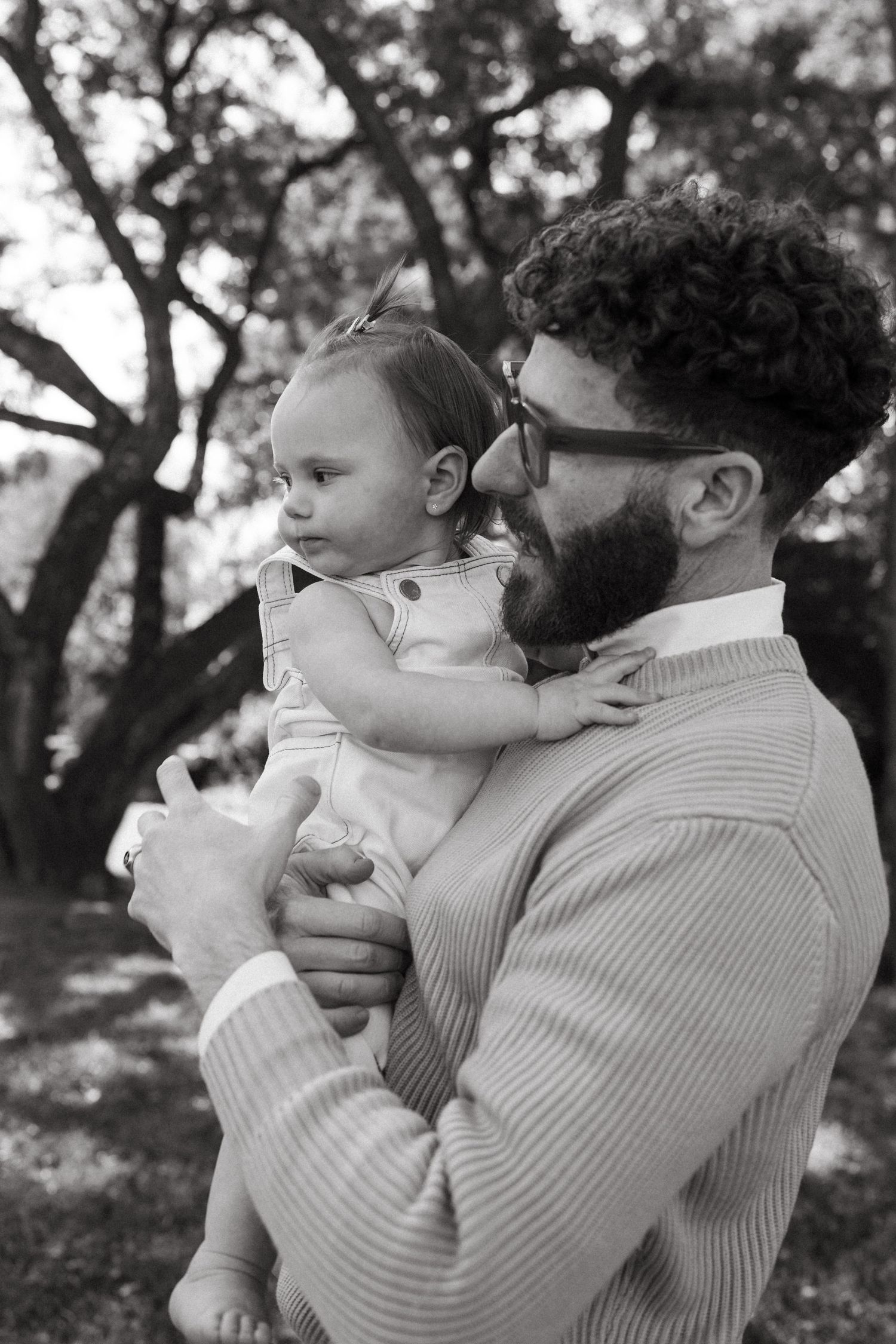 Sweet candid moments between parent and child in an outdoor setting.
