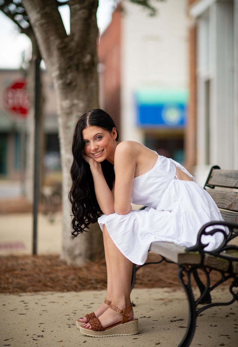 Girl sitting on street bench