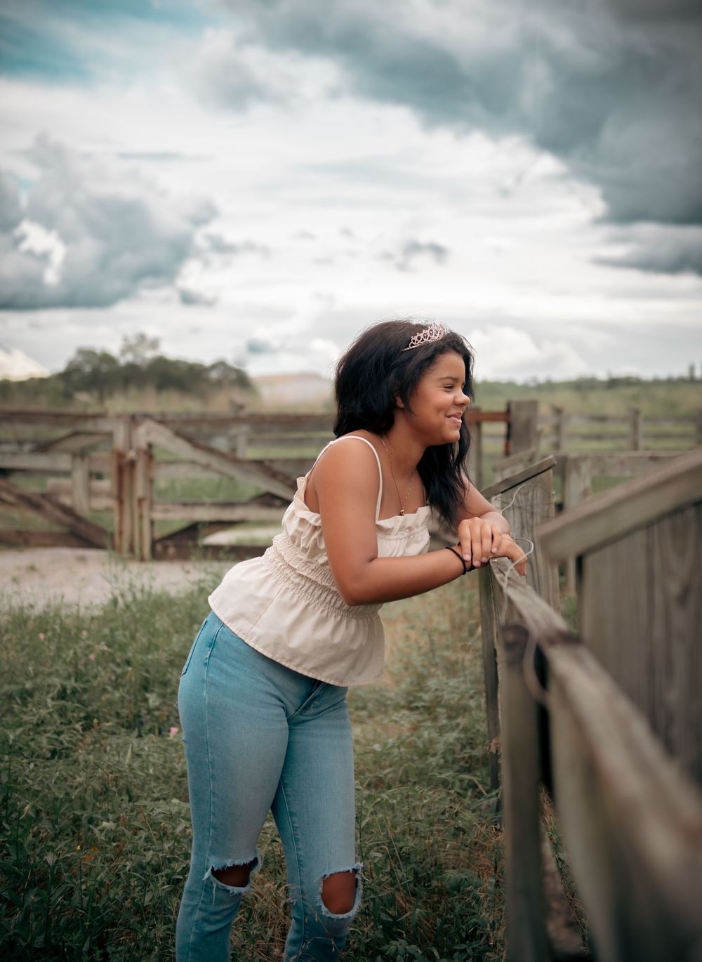 Girl laughing on a cloudy day in a field