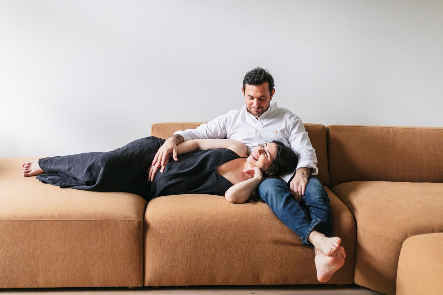 A cozy moment of relaxation on a tan leather couch in a minimalist living room.