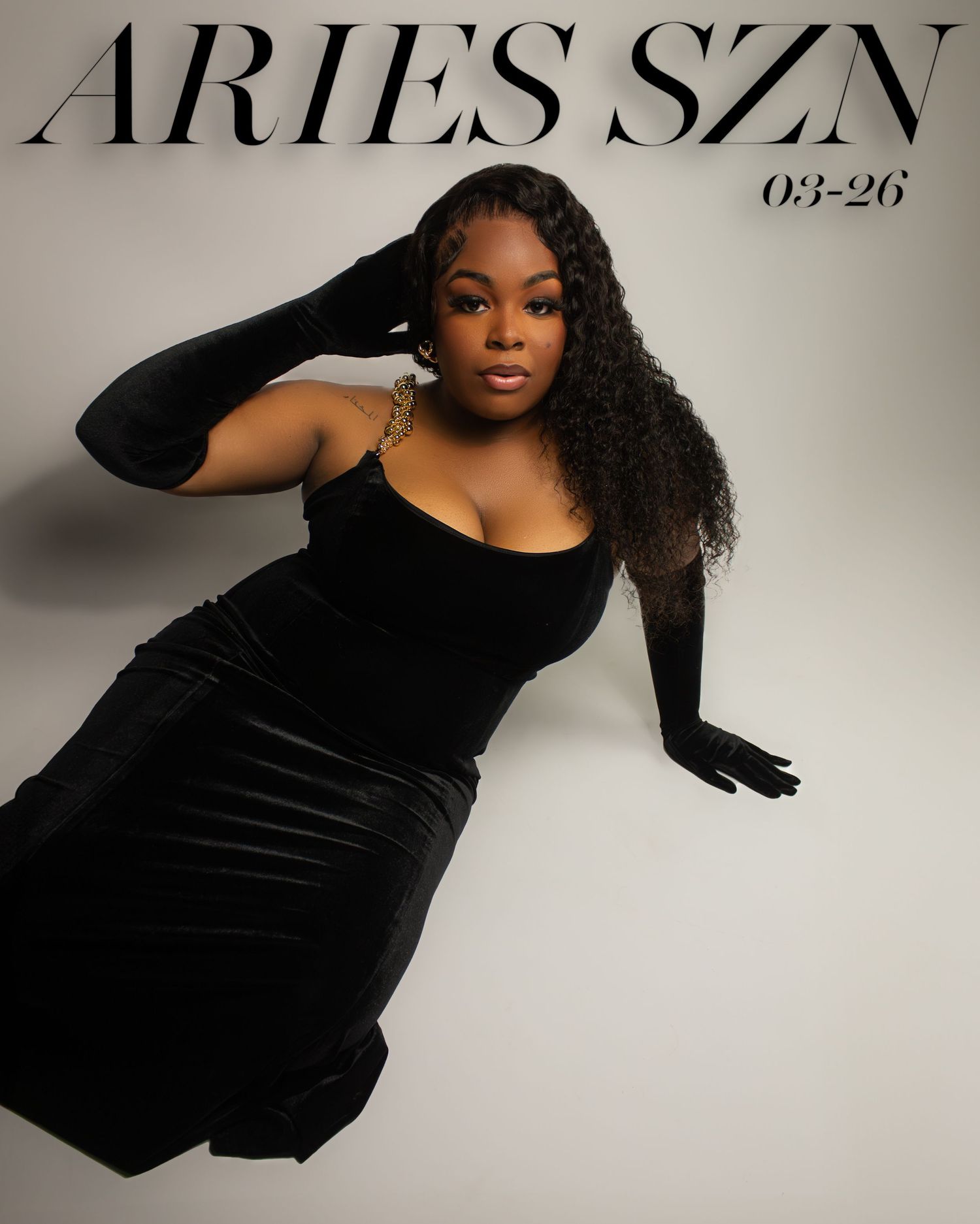 Fashion magazine cover featuring model in black velvet dress against light background.