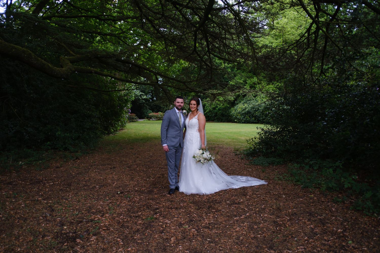 Bride and Groom in the grounds at Weetwood Hall Hotel in Leeds.
