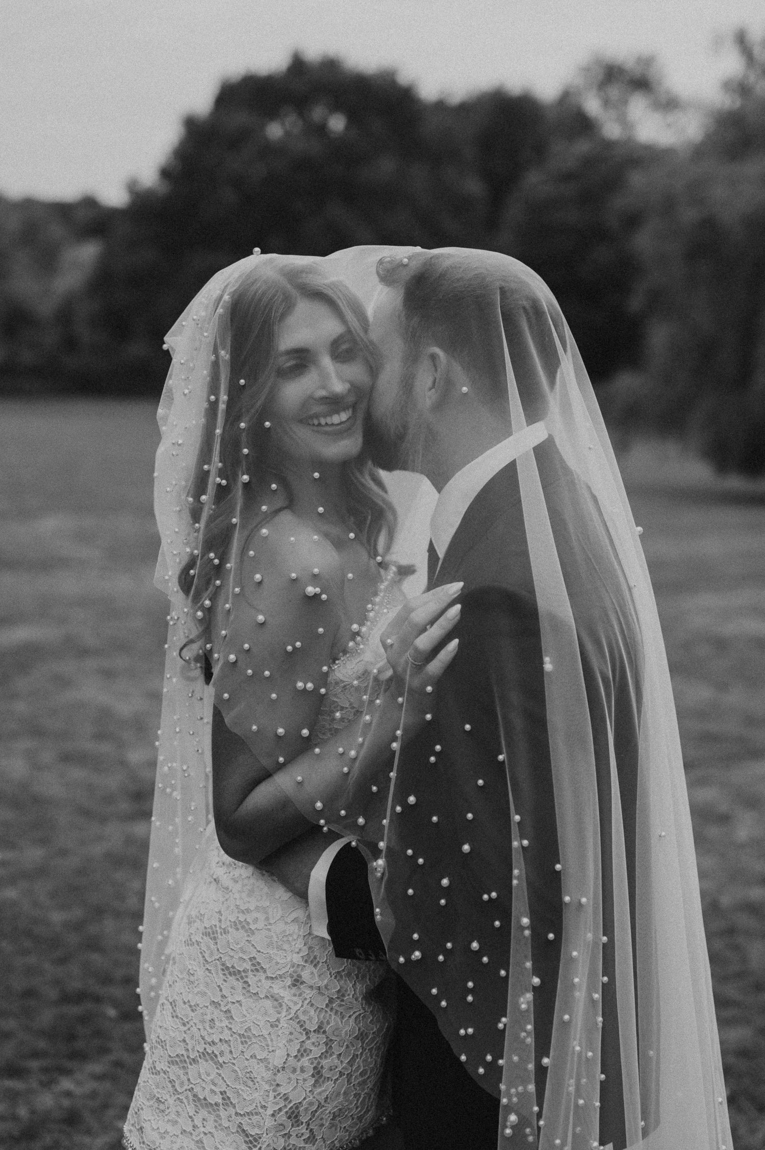 A sequence of black and white photos showing a bride and groom preparing for their wedding ceremony in a bright room.