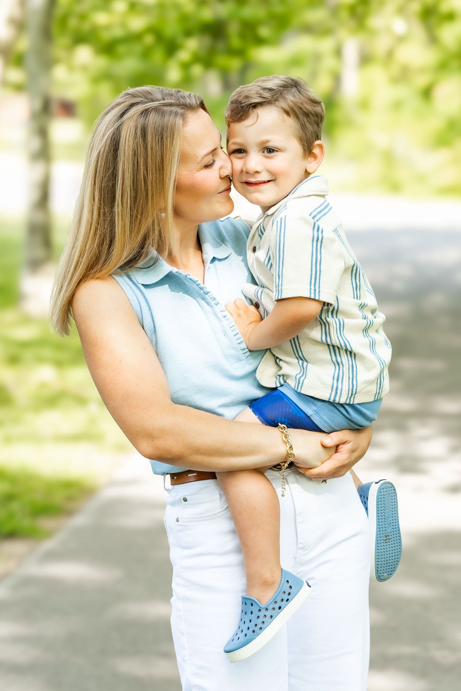 A joyful moment between parent and child against golden autumn foliage.