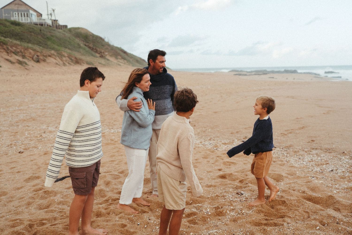 Family enjoying a playful day together at a scenic coastal beach.