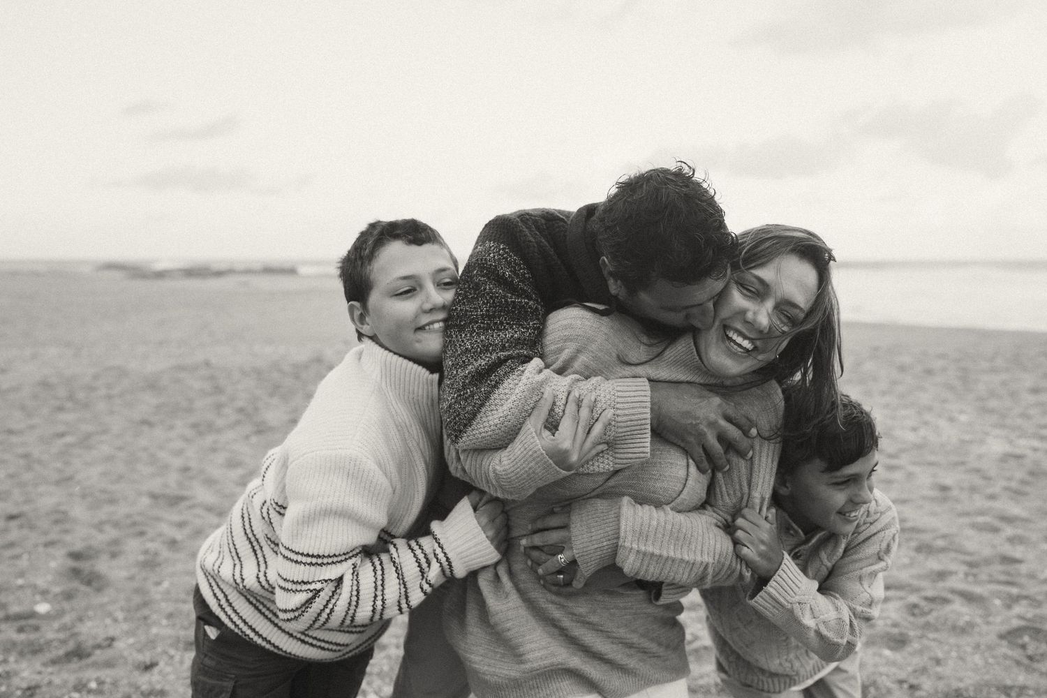 Group sharing a playful moment together on the sand.
