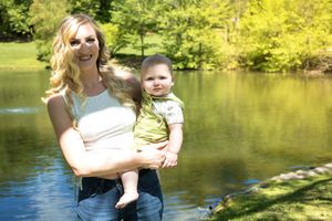 Natural outdoor photography by lake with warm golden lighting and green foliage.