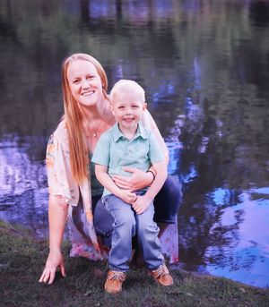 Mother and child bonding during sunset photoshoot by water.