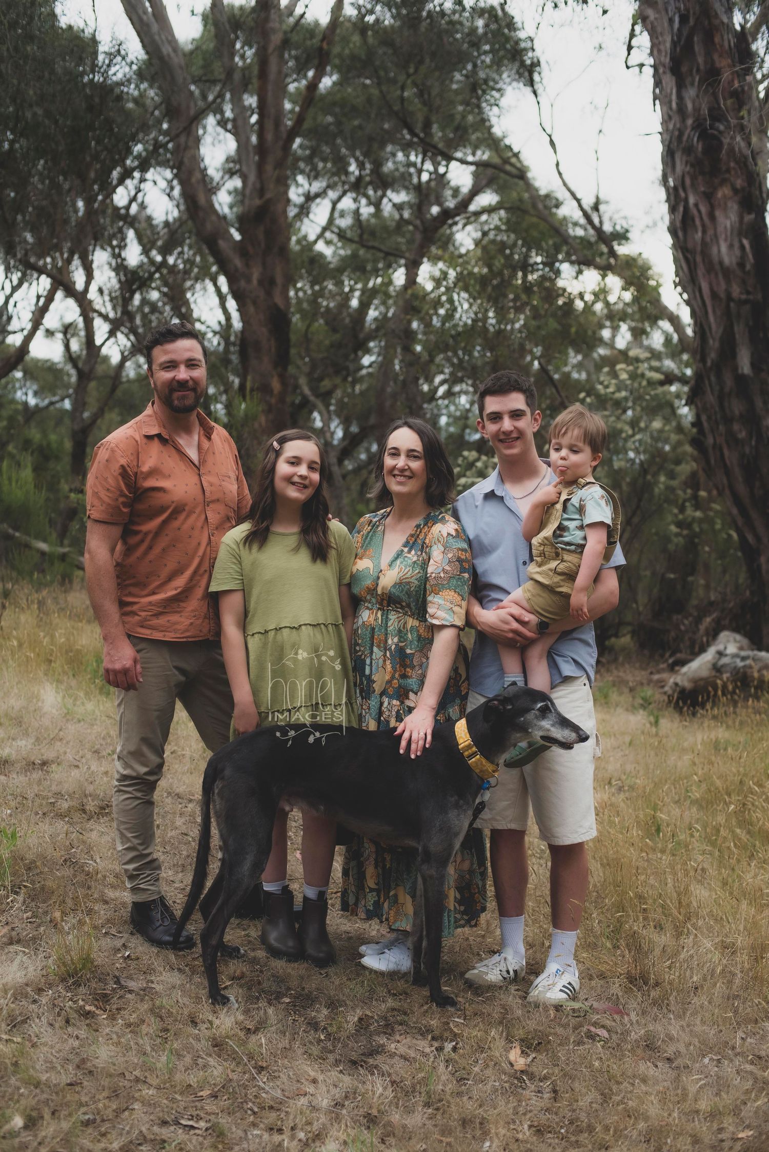 a family posing with their dog