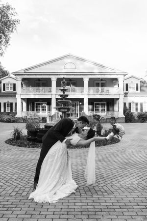 Orlando luxury wedding photographer bride and groom in black and white do a dip and kiss.