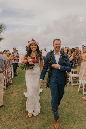 Orlando luxury wedding photographer captures the exit of a bride and groom at their ceremony.