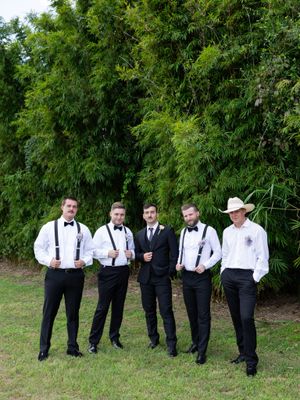 Orlando luxury wedding photographer groomsmen in black suits and posing for the photo.