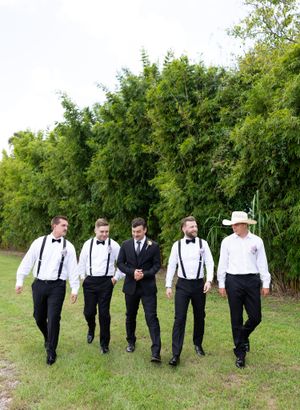 Orlando luxury wedding photographer capturing the groomsmen walking down the green grass.