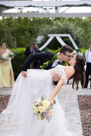 Orlando luxury wedding photographer bride and groom do a dip and kiss at the ceremony.
