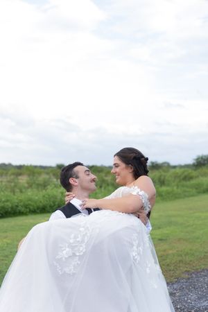 Orlando luxury wedding photographer bride and groom having a moment together in a green field.