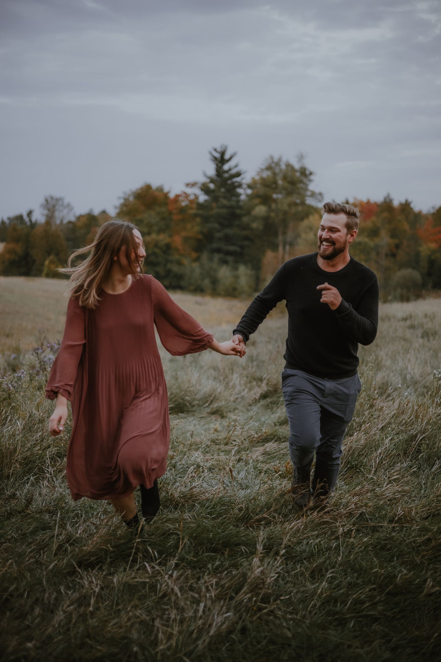 A couple laughing with each other on a fall day