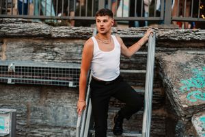 A collection of urban fashion photos featuring someone posing near metal railings in streetwear.