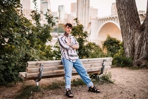 A series of outdoor lifestyle photos showing someone seated on a wooden bench in a casual denim outfit.