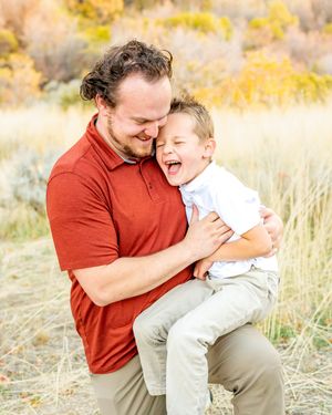 Playful moment captured between two figures against autumn mountain backdrop at Hidden Valley Park.