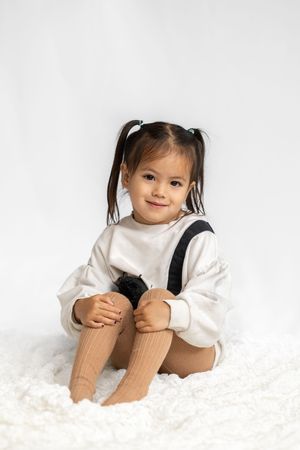 Toddler sitting on the ground in studio in Saratoga Springs.