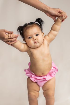 Chunky baby being held up in studio in Saratoga Springs.