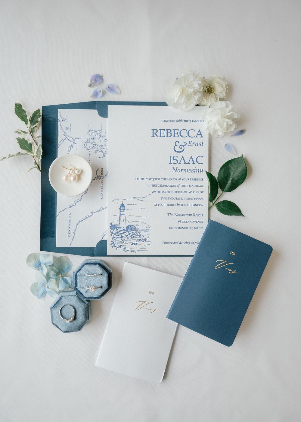 Elegant navy blue and white wedding invitation suite with floral details.