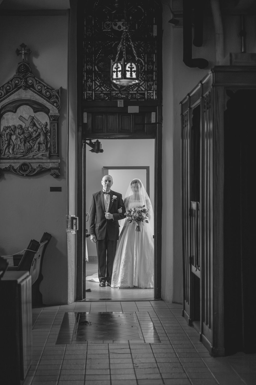 A black and white photo series showing a couple walking down a church hallway in wedding attire.