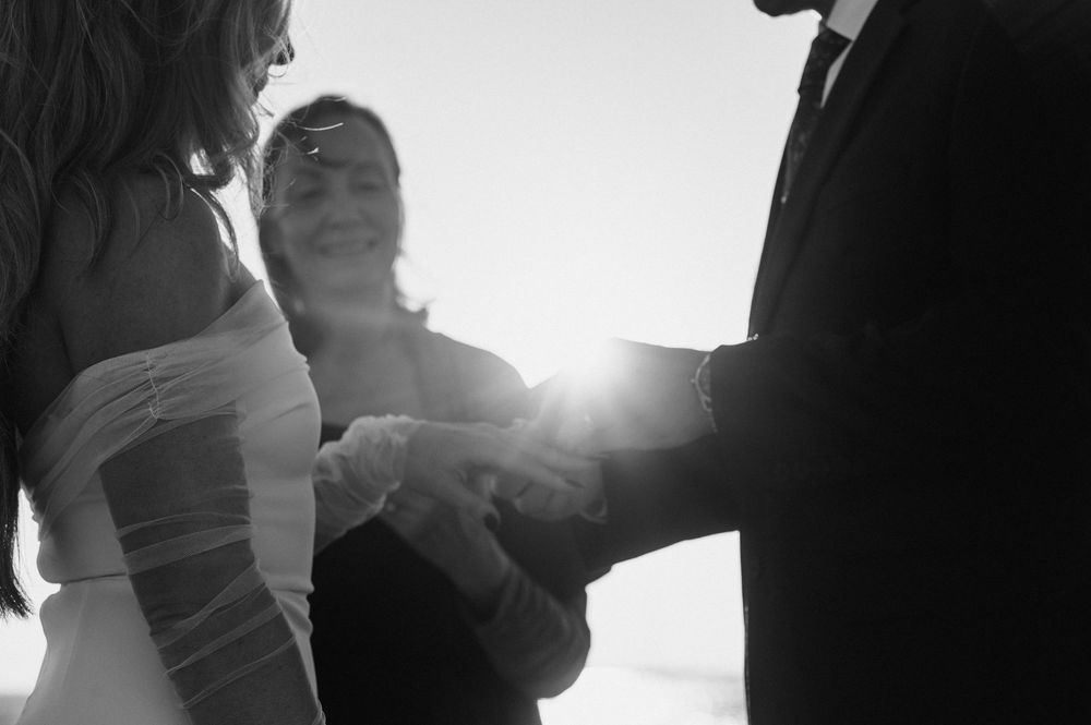 A silhouetted couple dances together in dramatic backlighting creating a romantic atmosphere.
