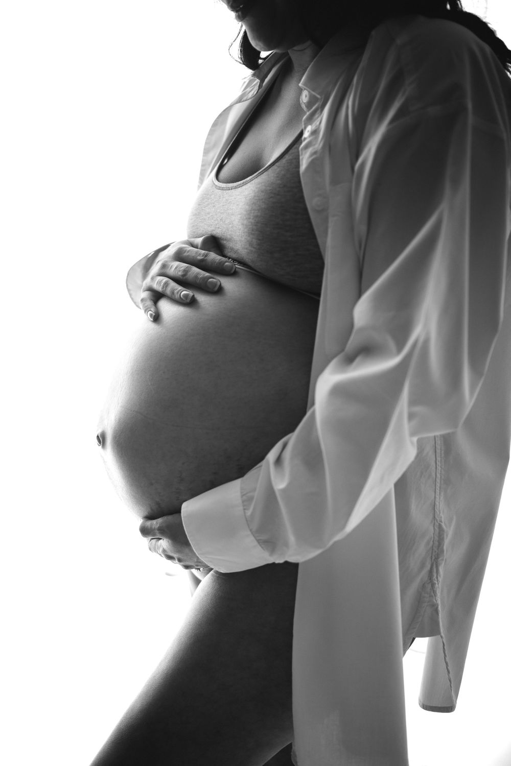 Black and white silhouette pregnant woman's belly taken in studio in Clarksville Tennessee by Disney Magic Photography, newborn photographer