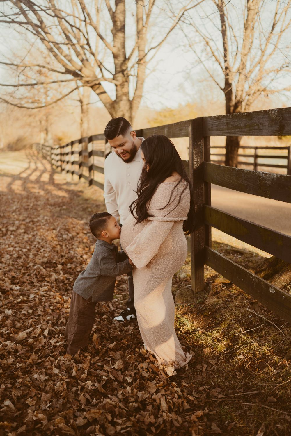 Toddler kisses mom's belly during photos in Franklin, Tennessee with Disney Magic Photography, Nashville Clarksville newborn photographer