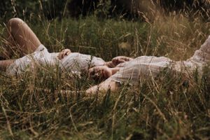 Film still of 2 women lying in grass. Photo by Samantha Bateman.