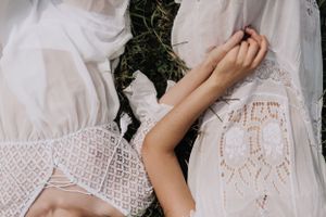 Film still of two women lying in grass. Photo by Samantha Bateman.